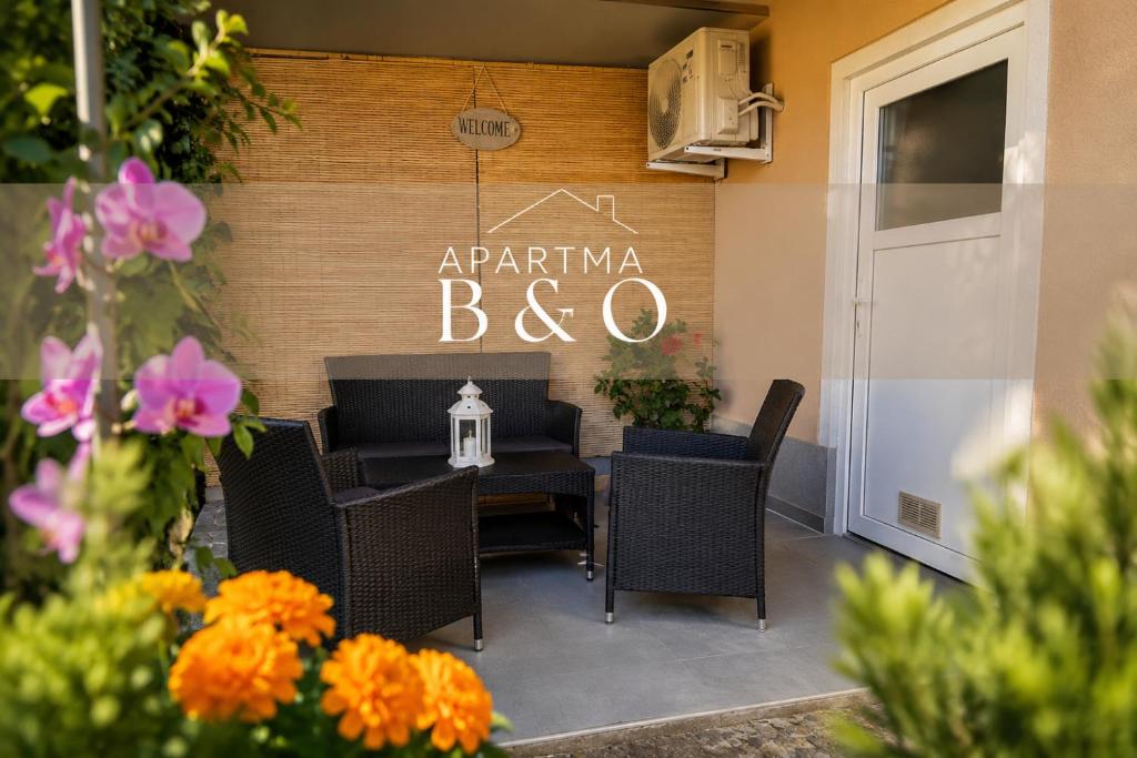 a restaurant with a table and chairs and flowers at Apartma B & O in Idrija