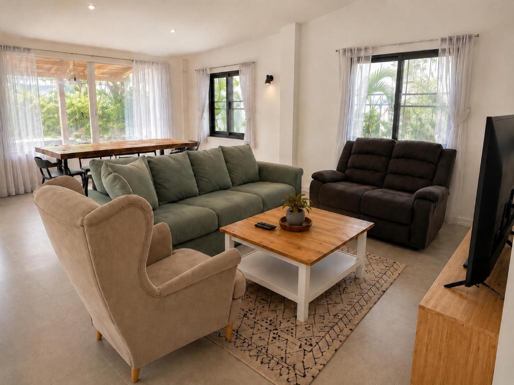 a living room with a couch and a table at Sawan villa in Hinkong