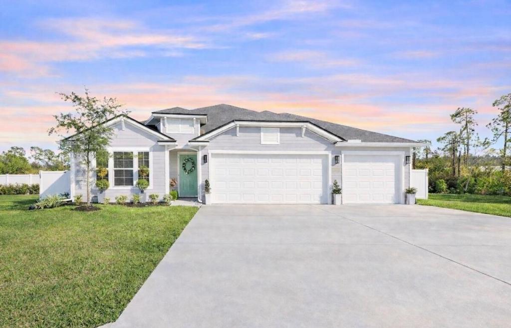 a white house with a driveway at Rybark Manor in Palm Coast