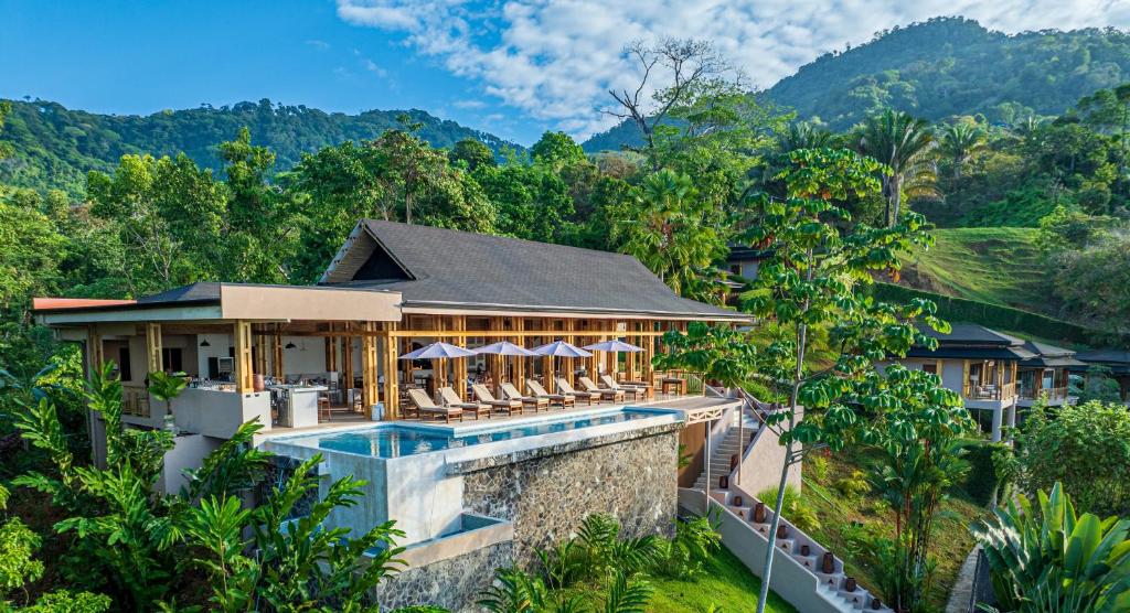 an aerial view of a resort with a swimming pool at Tiki Villas Rainforest Lodge - Adults Only in Uvita
