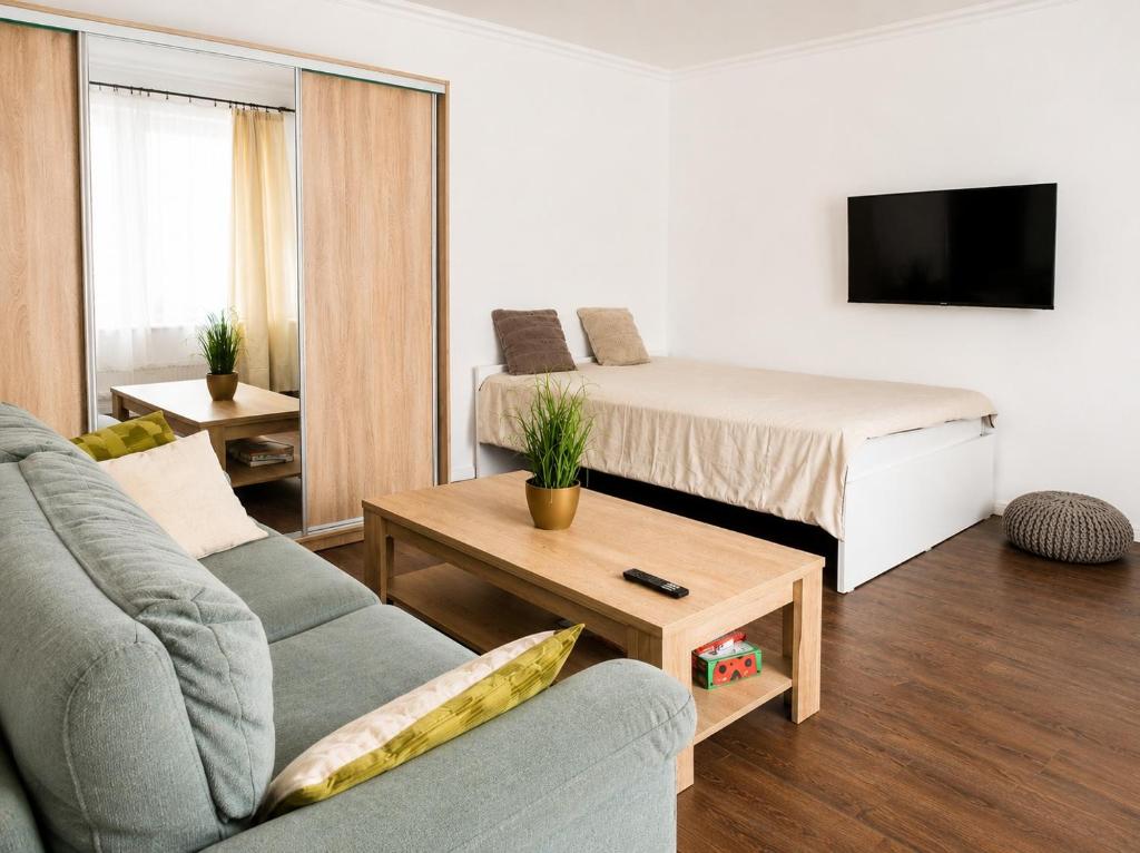 a living room with a bed and a couch at Garden Home in Törökbálint