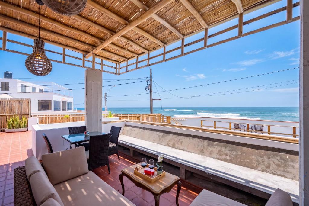 a patio with a view of the ocean at El Templo Surf House in Punta Hermosa
