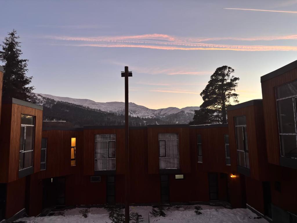 a cross on top of a building in the snow at Fughuro cottage in Bakuriani