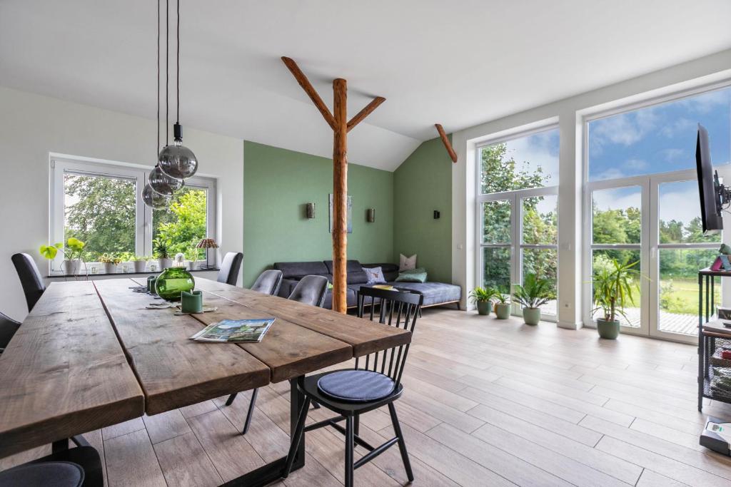 a living room with a wooden table and chairs at Hof Wuushöh in Stolk