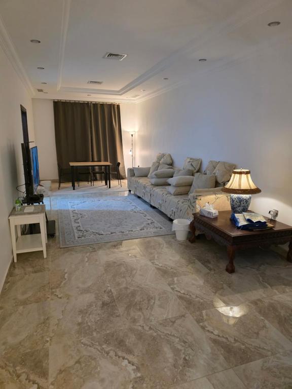 a living room with a couch and a table at Khiran City in An Nāmī