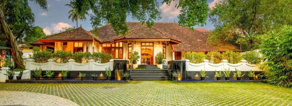 a house with a staircase in front of it at Amritha Heritage in Trivandrum