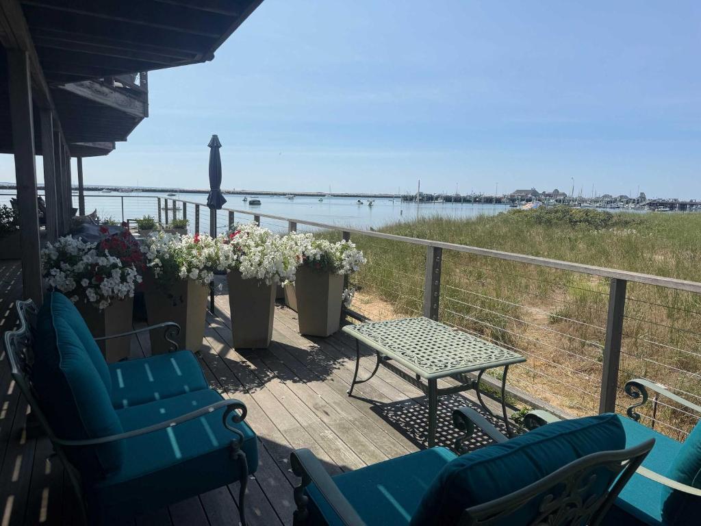 a porch with chairs and a table and a view of the ocean at Bayview Escape in Provincetown
