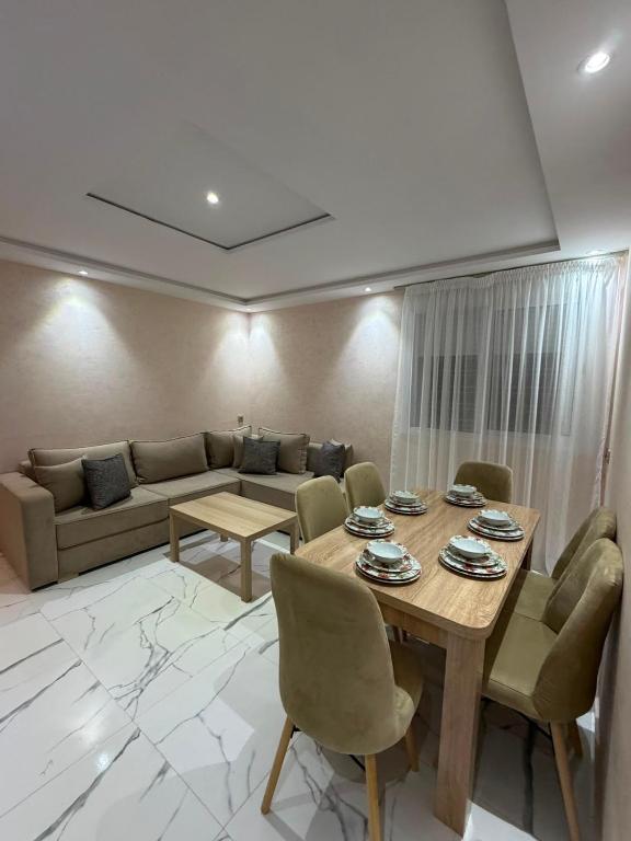 a living room with a table and a couch at Apartment with pool in Asilah