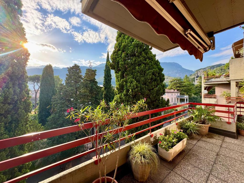 a balcony with plants and a view of the mountains at 1Dest - Garda Vintage in Arco
