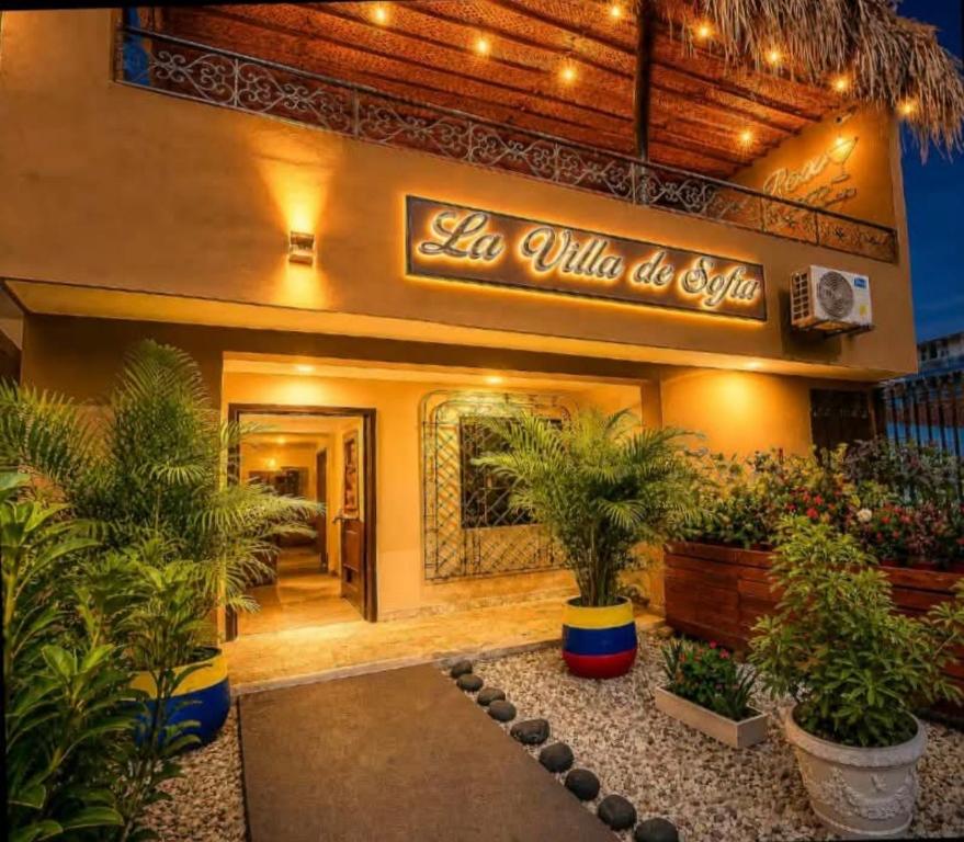 a restaurant with a sign on the front of it at La Villa de Sofia in Santa Marta