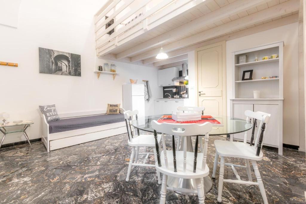a kitchen and dining room with a table and chairs at Rondinelle by Palazzo Refolo in Martano