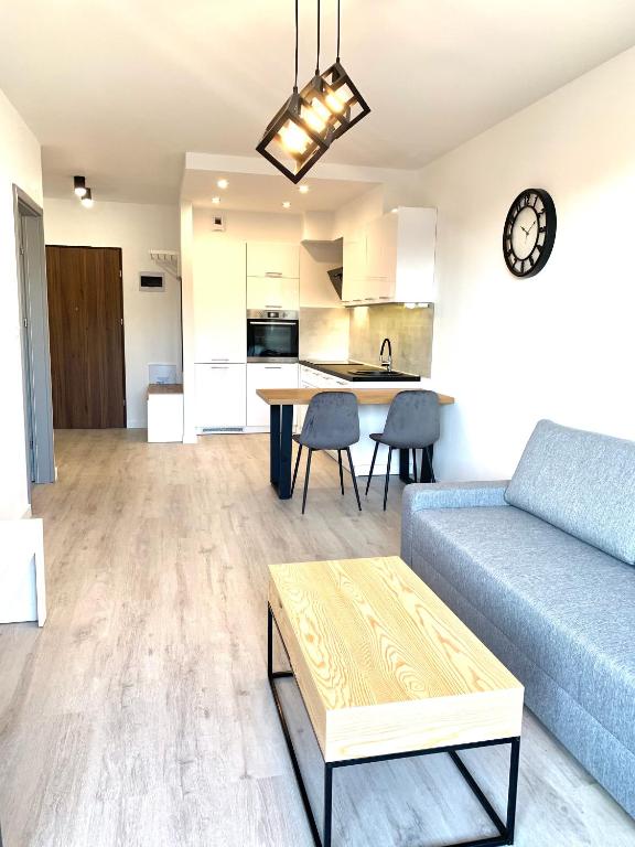 a living room with a couch and a table at Apartament z widokiem na las in Tychy