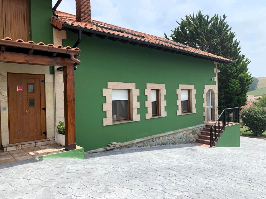 a green house with a door and a staircase at R2R - Casa Los Abuelos - C19A02 in Gormazo