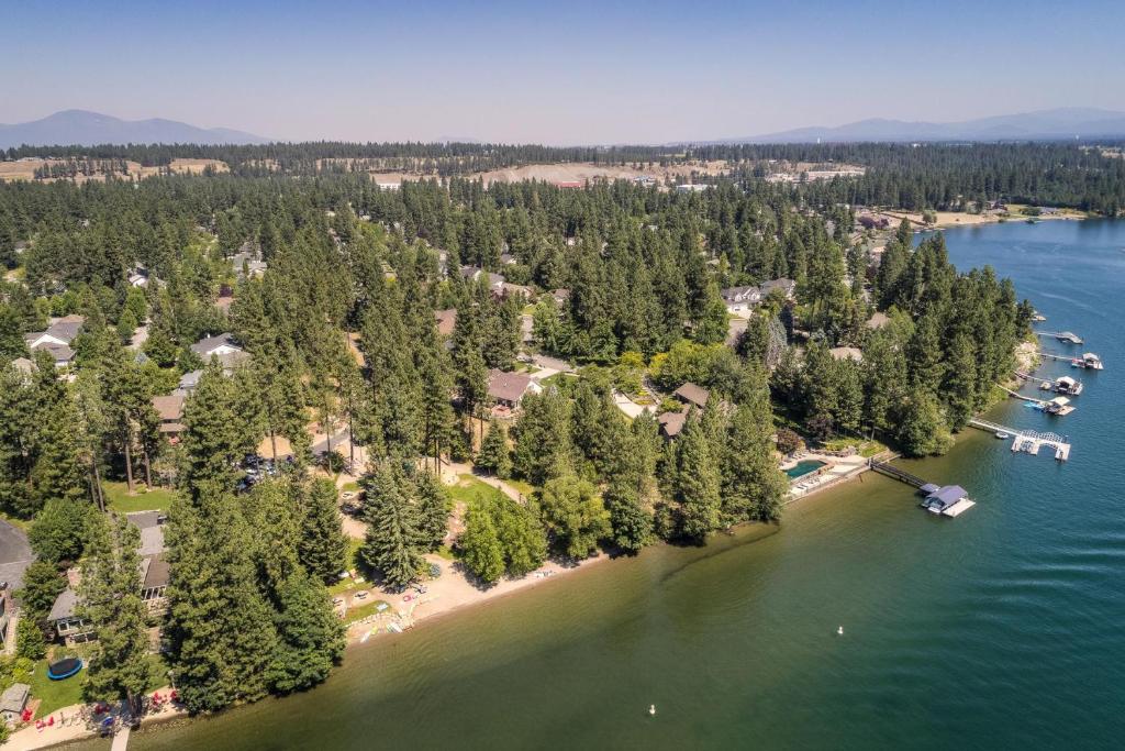 an aerial view of a beach with trees and water at Riverside Harbor House in Post Falls ID in Post Falls