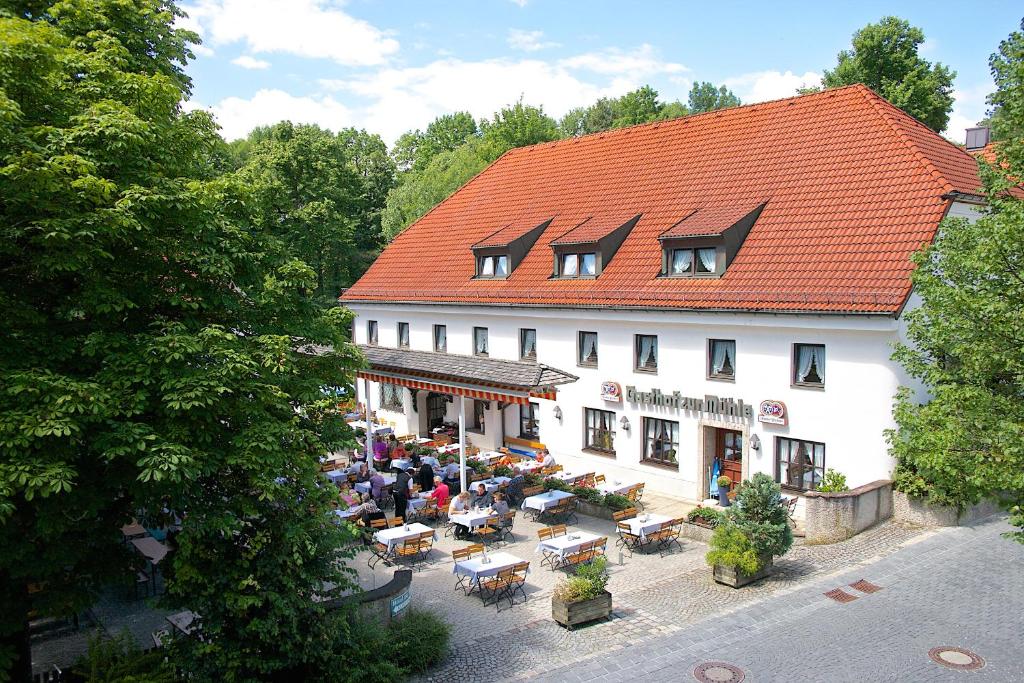 una vista aérea de un edificio con mesas y sillas en Hotel zur Mühle, en Ismaning