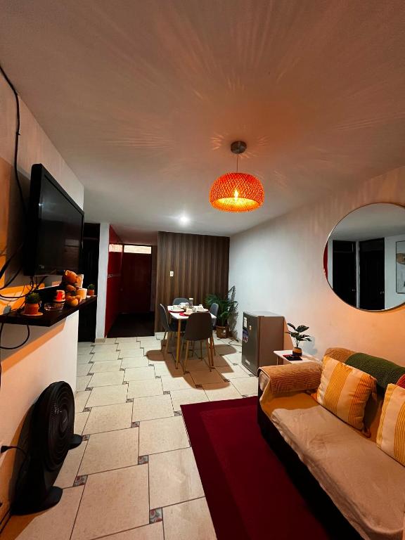 a living room with a couch and a table at Palmeras house in Ica