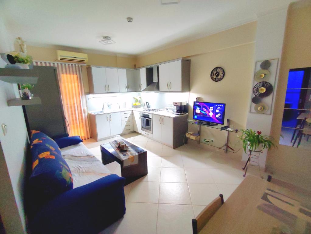 a living room with a couch and a kitchen at CS apartment Patra in Patra