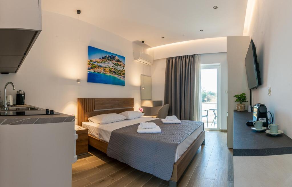 a hotel room with a bed and a kitchen at Aimilia Boutique Studio Kalathos in Kalathos