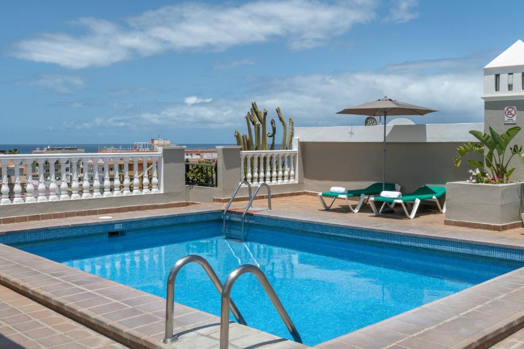 a swimming pool on the roof of a building at Hotiday Tenerife Norte in Puerto de la Cruz