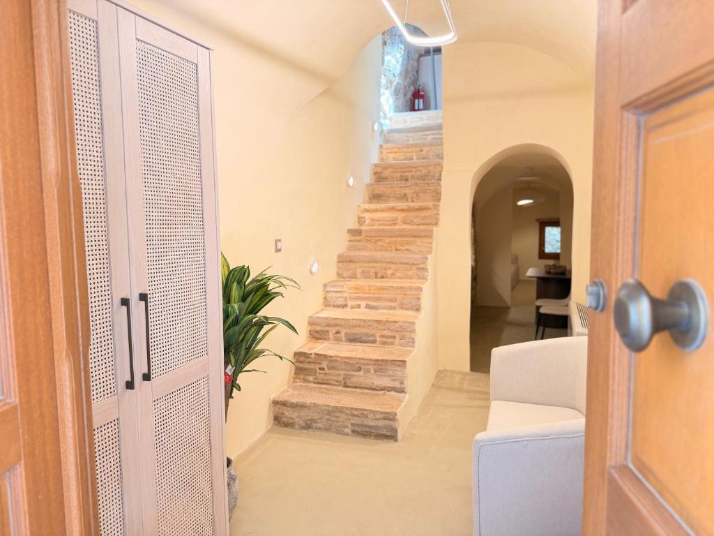 a hallway with a staircase in a house at Luxe Lane Kalamoti in Chios