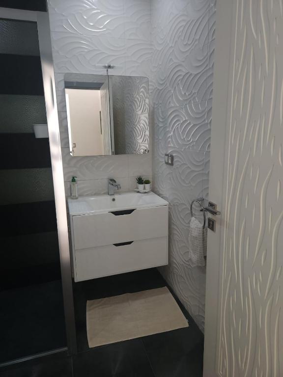 a bathroom with a sink and a mirror at Huge oceanfront apartment in Tétouan