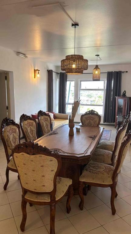 ein Esszimmer mit einem Holztisch und Stühlen in der Unterkunft Diamond View in Quatre Bornes