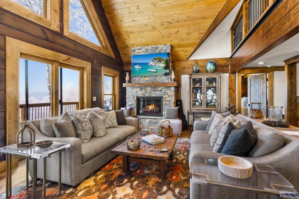 a living room with a couch and a fireplace at Shawnee Ridge Lodge in Banner Elk