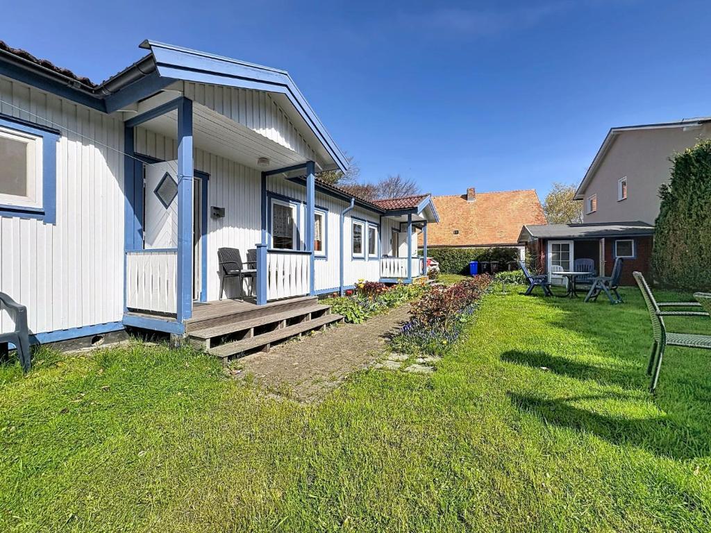 a house with a porch and a bench in a yard at Apartment Gabi-2 by Interhome in Wiek auf Rügen