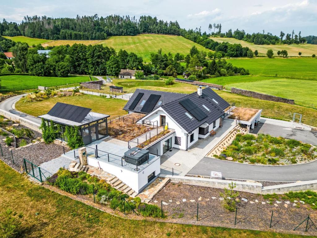 an aerial view of a white house with solar panels on it at Studio V Šachu-4 by Interhome in Dačice