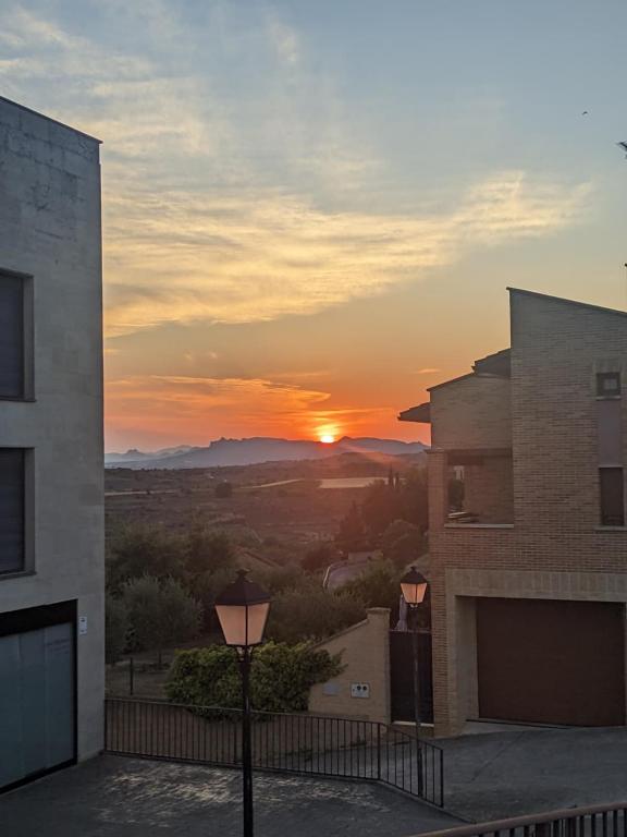 a sunset seen from a balcony of a building at Apartamento cerca de Haro in San Vicente de la Sonsierra