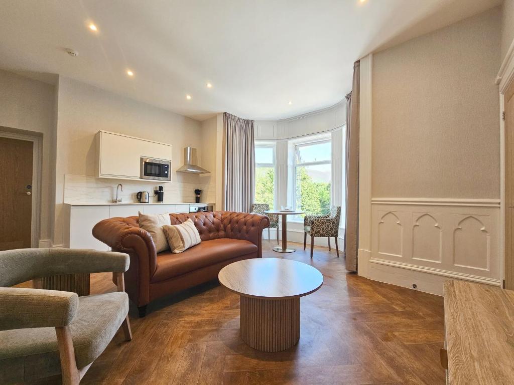 a living room with a couch and a table at Derwent Manor Apartments & Rooms in Keswick
