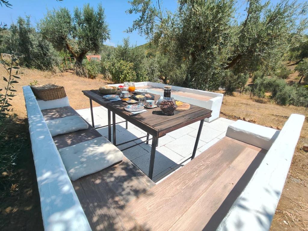 a picnic table with two benches and food on it at Alegria rustica 2 Rustic happiness in Envendos