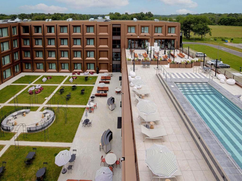 an overhead view of a hotel with a swimming pool at TRIBE Milano Malpensa in Vizzola Ticino