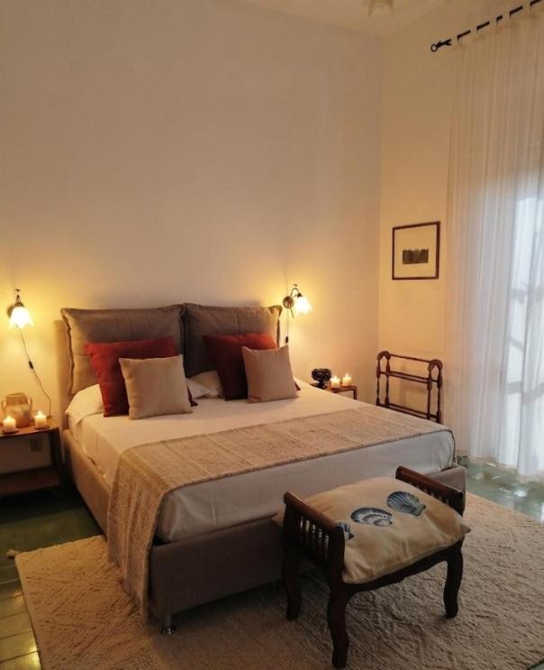 a bedroom with a large bed and a chair at Il Mulino in Locri