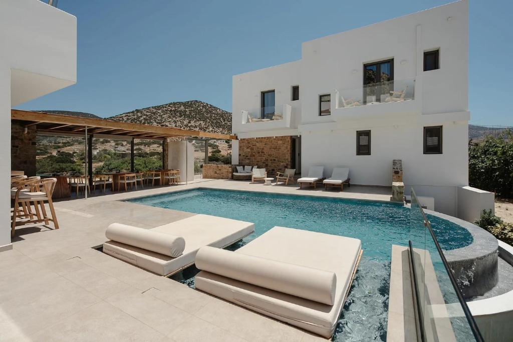 a villa with a swimming pool and a patio at Axopetra Boutique Hotel in Agiassos