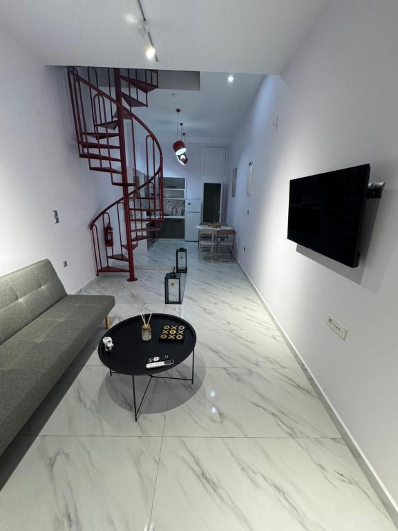 a living room with a couch and a table at EVE's house 6 - Corinth center loft in Korinthos