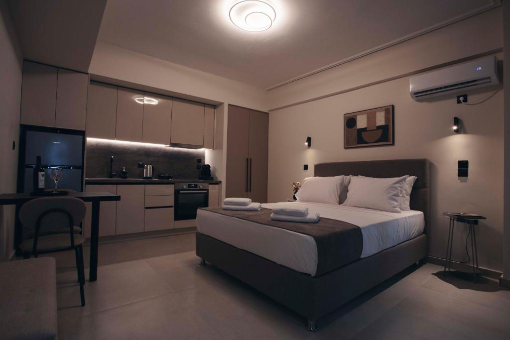a bedroom with a large bed and a kitchen at Luna house in Chalkida