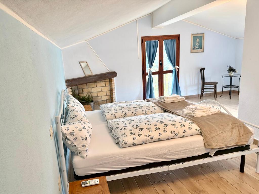ein Schlafzimmer mit zwei Betten in einem Zimmer in der Unterkunft Ferula romantica mansarda tra fiumi e montagne Sardegna in Seùlo