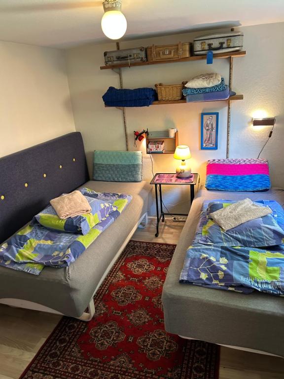 a living room with two beds and a couch at Genbrugsfabrikkens Tiny apartment in Holbæk