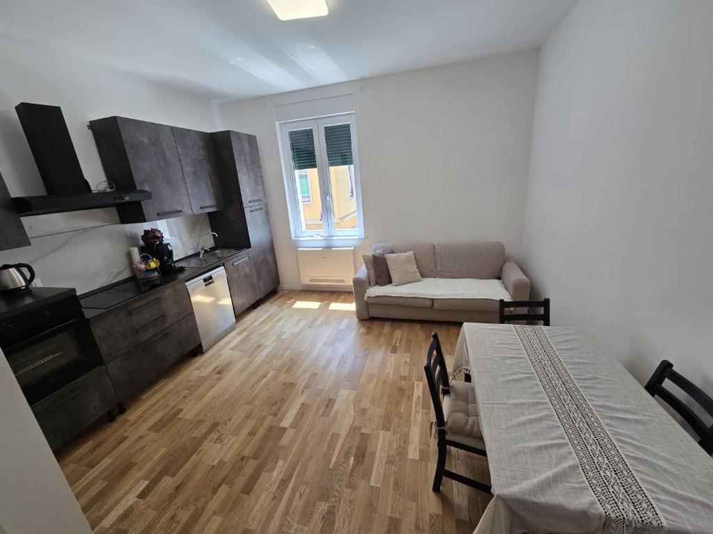 a living room with a couch and a table in it at Appartamento Saffi in Faenza