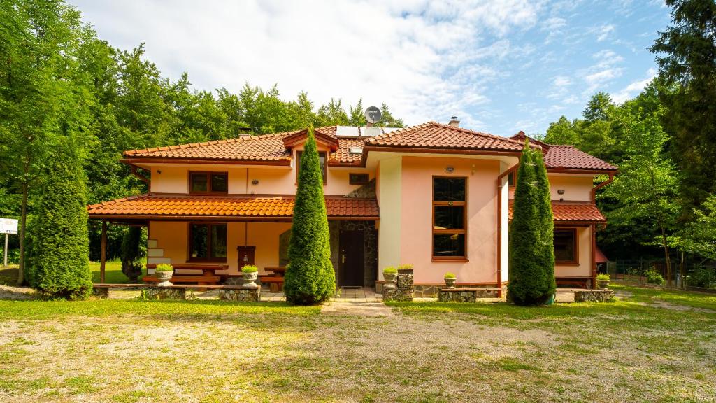a large house with trees in front of it at Chata Motocentrum in Snina