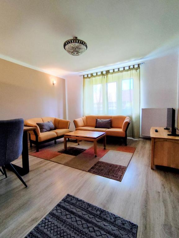 a living room with couches and a coffee table at Apartmán 24 in Medzilaborce