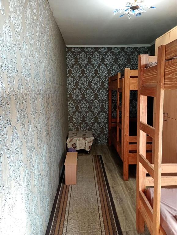 a bedroom with two bunk beds and a ceiling at Hostel COMFORT in Mukacheve
