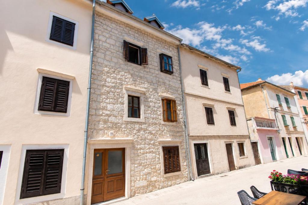 a group of buildings in a street at Apartment Rustika Skradin in Skradin