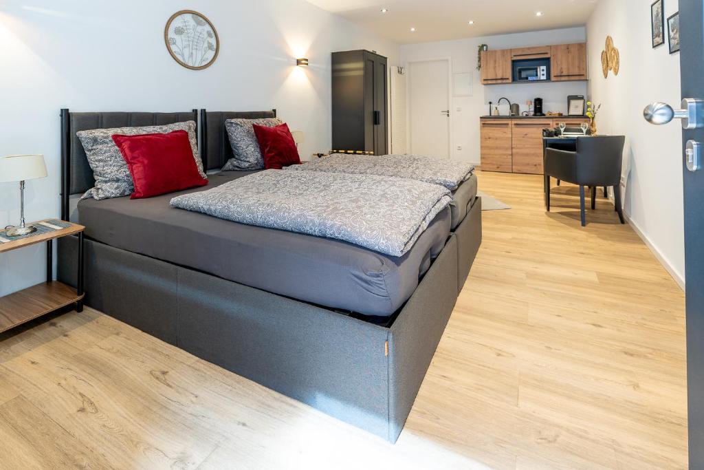 a large bed in a room with a kitchen at Ferienwohnung 2 Gasthaus Bußmann in Vreden