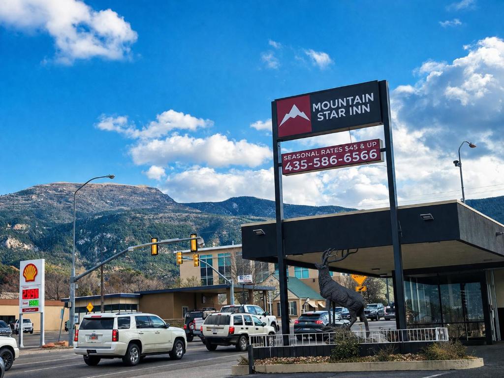 a sign for a mountain star inn in a parking lot at Mountain Star Inn Cedar City in Cedar City