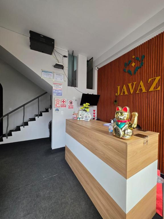 a restaurant with a counter with a sign on the wall at Javaz Hospedaje in Tarapoto