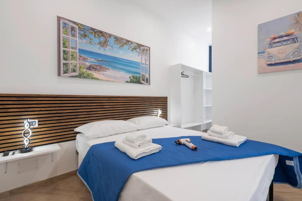 a bedroom with two beds with towels on them at Bikers Rooms in Sestu