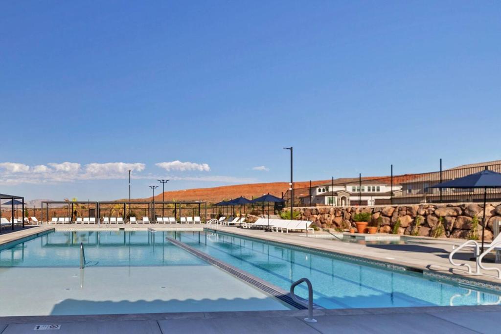 a swimming pool at a resort with the ocean in the background at Heated Pool & Pickleball - Spacious & Immaculate Home in Washington