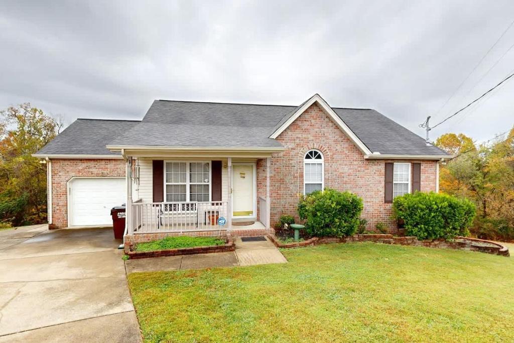 a brick house with a porch and a yard at Mount Juliet Charmer in Hunters Store